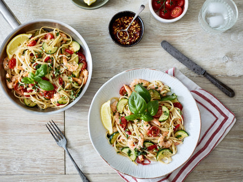 Pasta dish with vegetables on a wooden table