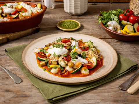 Plated dish of vegetables with a wooden table setting