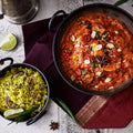 Two bowls of different types of food on a patterned surface with garnishes.